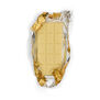 A white chocolate bar with packaging open. The bar is wrapped in gold foil and paper packaging.